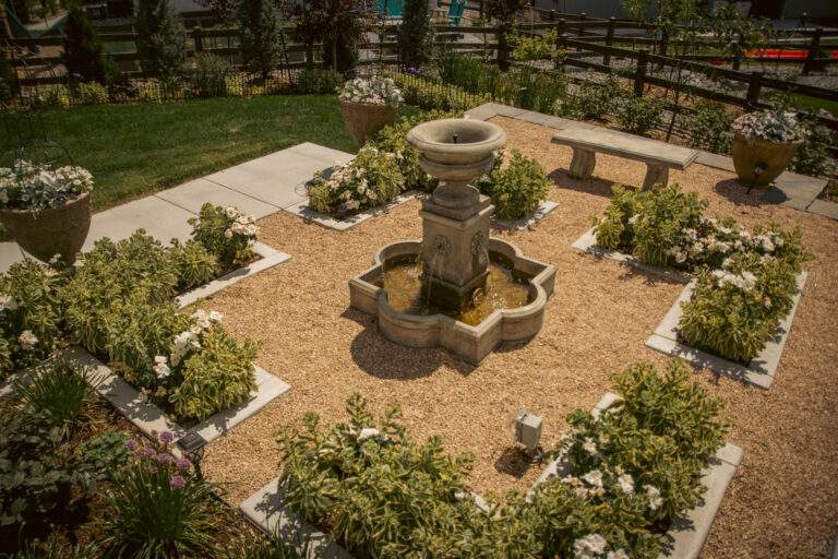 elegant stone water feature in estate style garden