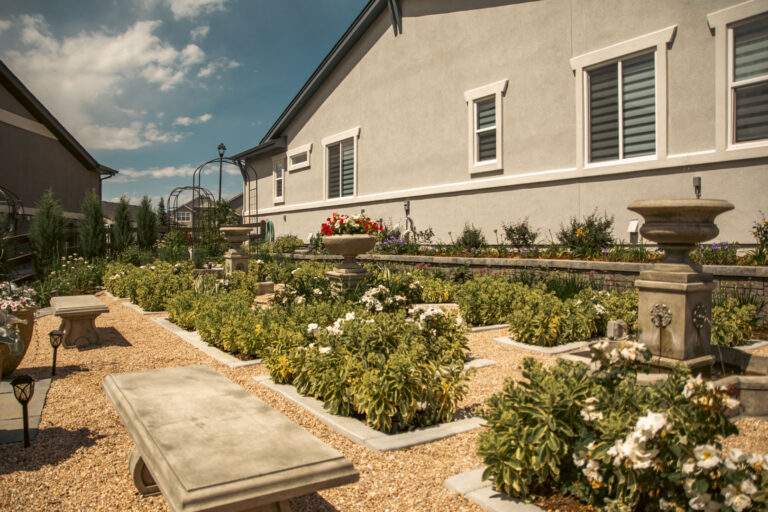 Stone bench in garden with rock pathway