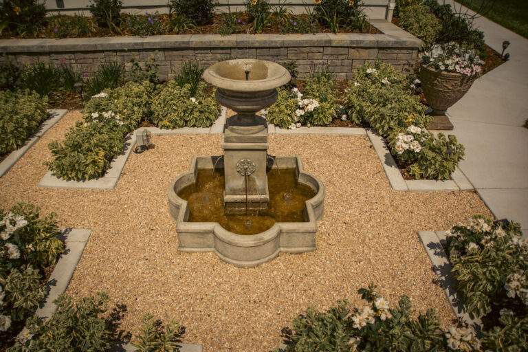 elegant stone water feature in estate style garden