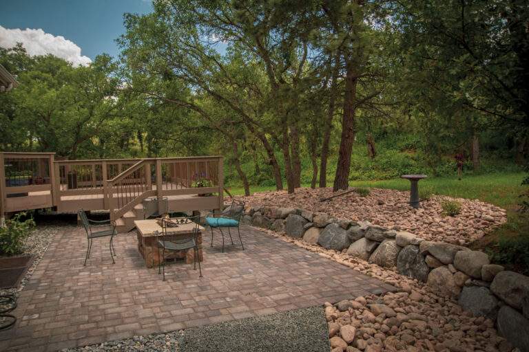 Paver patio with fireplace and deck
