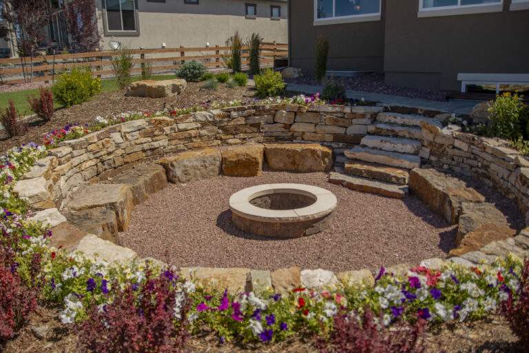 Sunken firepit with stone retaining wall and steps.