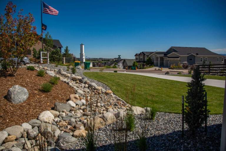 Turf with xeriscaping and American flag