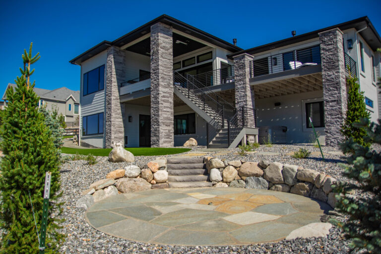 Flagstone patio with artificial turf and trees